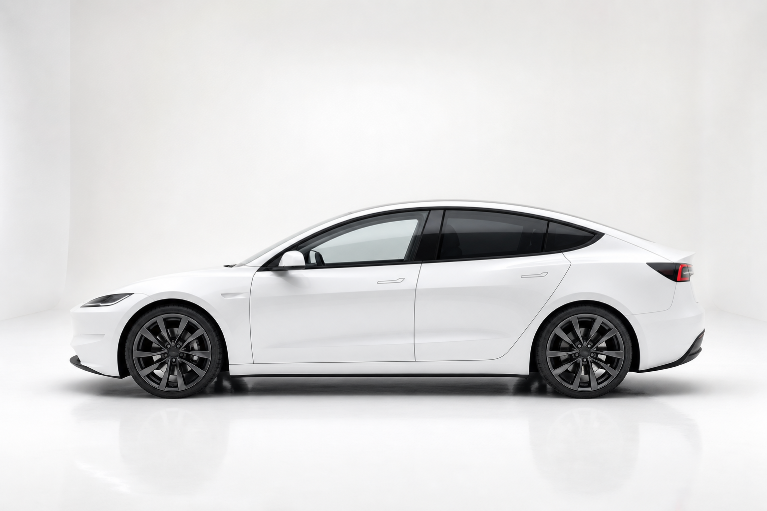 White Tesla with dark rear tint in the Autotint studio